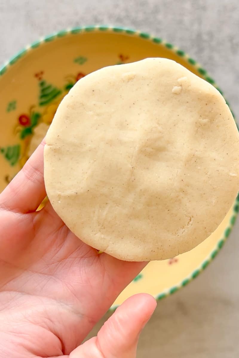 Make a ball of dough with your hands and with your hand start molding the masa to make a saucer shape the size of the palm of your hand, about ¼ inch thick. 