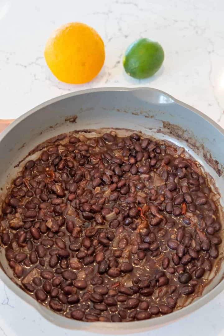 These Chipotle Black Beans Recipe contain black beans, olive oil, onion, garlic, chipotle, bay leaves, limes and cilantro. 