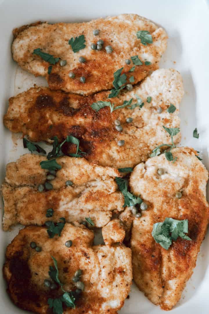 This Chicken Piccata Milanese is made with chicken breasts, flour, eggs, bread crumbs, capers, lemons, broth, and parsley. 