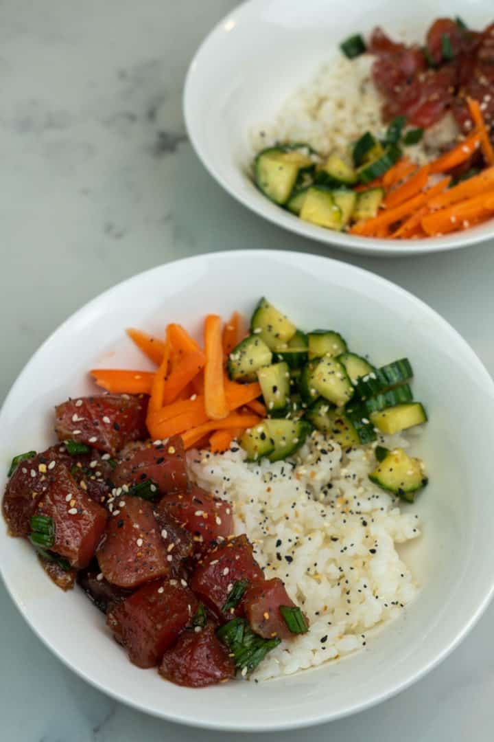 This Hawaii Poke has chunks of tuna, avocado, cucumber, carrots, sesame seeds, green onion soy sauce, sesame oil and spicy mayo!