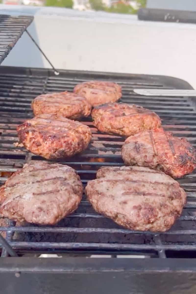 Grill the burgers for about 5-8 minutes per side. You should cut the thickest patty and check the inside to see if you need to cook for longer.  When the burgers are almost done, add the cheese and allow to melt. 