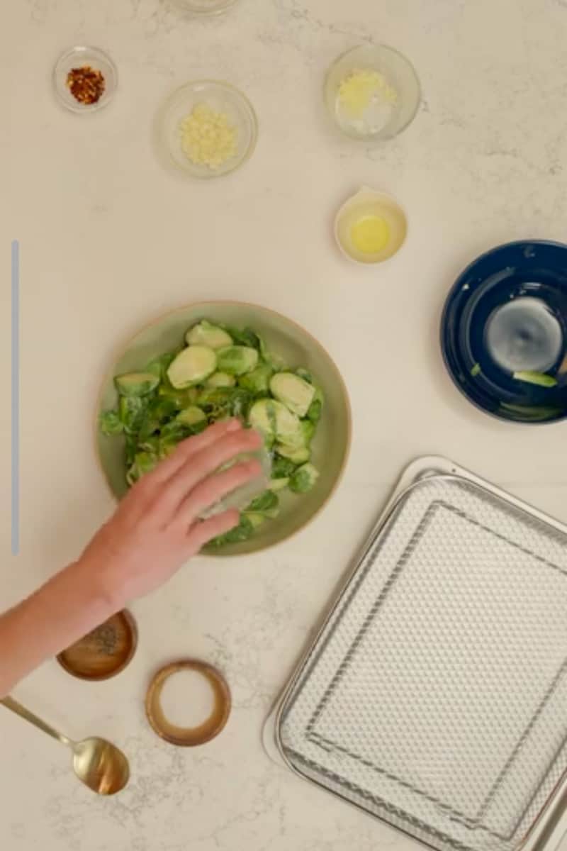 Place the coated brussels sprouts in the air fryer basket or baking sheet. See recipe card below for cooking options. Top with grated parmesan cheese. Enjoy these Dijon Brussel Sprouts with Cheese!