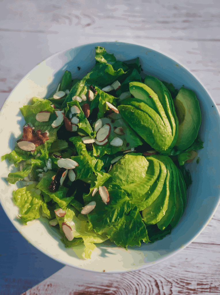 This Sun Dried Tomato and Bacon Salad is made with romaine lettuce, avocados, sliced almonds, provolone, and sun-dried tomatoes. 