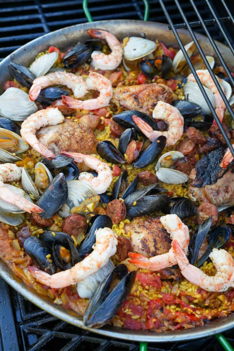 This Spanish Paella Recipe is made saffron, chicken legs, bomba rice, onion, tomato sauce, chorizo, shrimp, mussels, and clams.