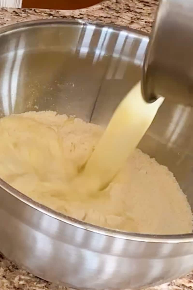 Preheat your air fryer to 350°F (175°C) for about 5 minutes. In a large mixing bowl, whisk together the all-purpose flour, cornmeal, sugar, and baking powder until well combined.