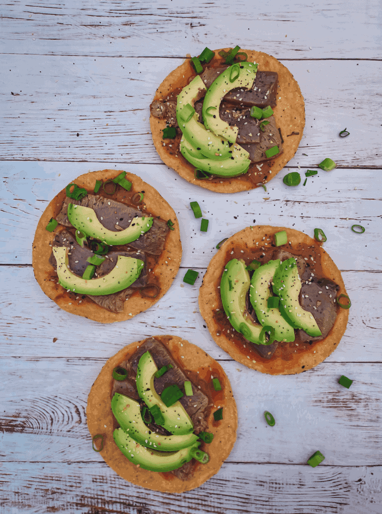 This Tuna Tostada is a lime and soy sauce marinated tuna on a tostada and garnished with a chipotle aioli, avocado, and scallions. 