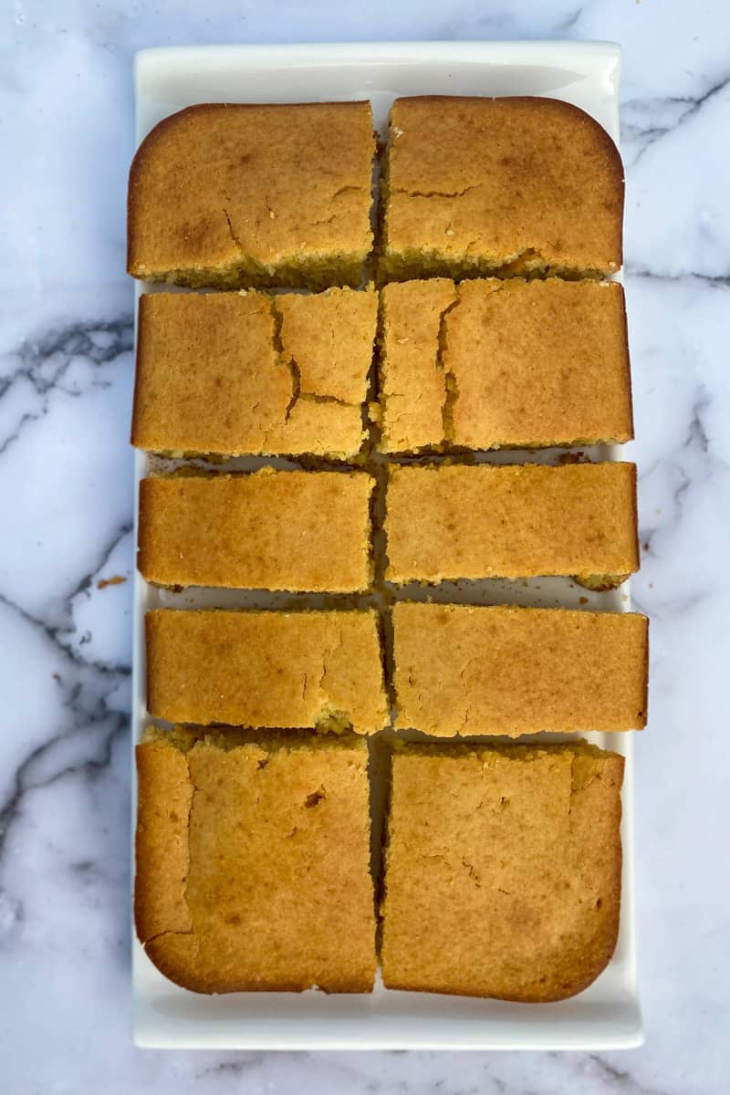 This Air Fryer Corn Bread Recipe is made with flour, corn meal, sugar, baking powder, whole milk, oil and eggs.