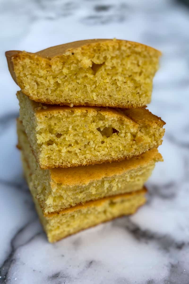 This Air Fryer Corn Bread Recipe is made with flour, corn meal, sugar, baking powder, whole milk, oil and eggs.
