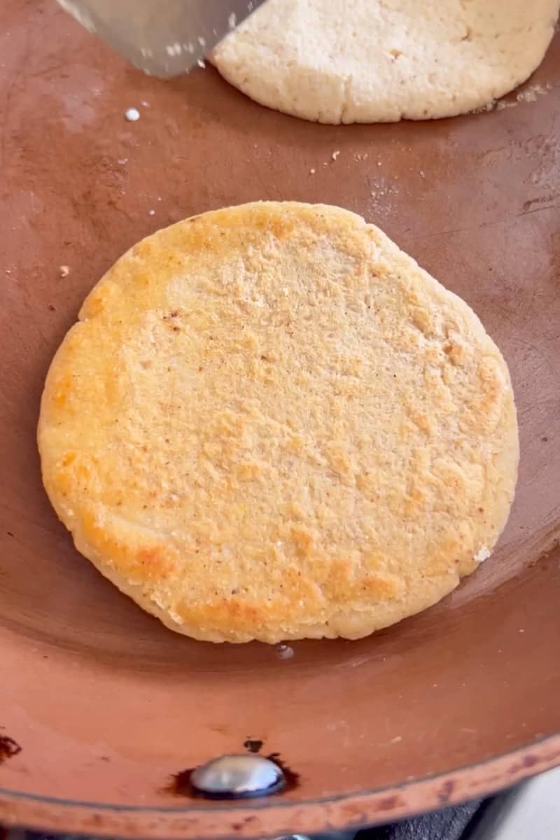 Heat a large pan or griddle over medium heat and wait for it to heat up. Grab a piece of dough and form into a ball, the size of a ping pong ball (this is to know how much to use). Pat into a flat circle and add on the dry pan. Heat up for a total of 5 minutes, turning frequently.