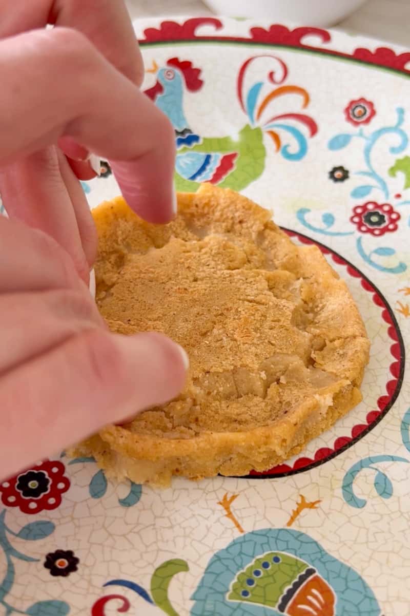 Once the dough is done, shape the sopes by pinching the border to form a wall. They must still be hot in order to do this. Set aside to cool. Fry the sopes. On medium heat, add ½ inch oil in a large deep pan.  Once the oil is hot, fry the sopes, flipping frequently until golden brown, about 5 minutes. Set aside on a plate with paper towels on it. Let the sopes cool.