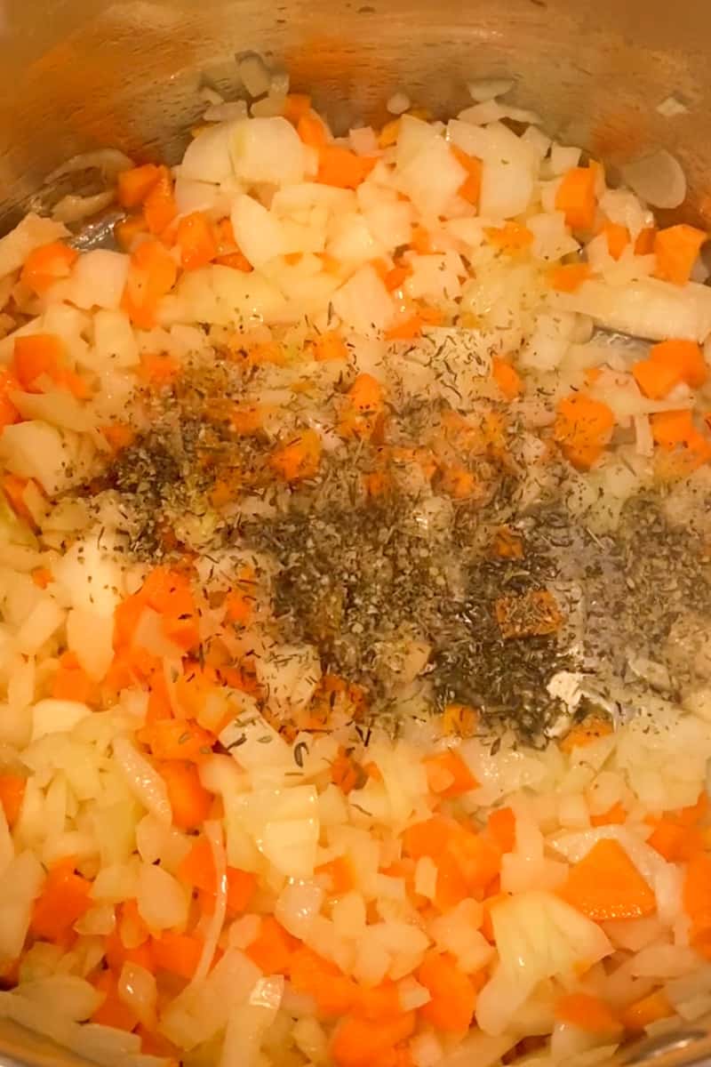 Heat the olive oil in a large pot or Dutch oven over medium heat. Add the onions and carrots to the pot and sauté until they start to soften, about 5 minutes. Stir in the marjoram and thyme, and cook for an additional minute to release their flavors.