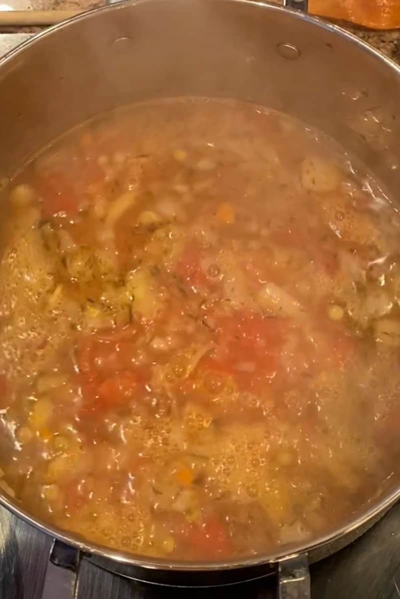 Stir in the dry white wine and continue to simmer for another 5 minutes to allow the flavors to meld together. Season the soup with salt and pepper to taste.