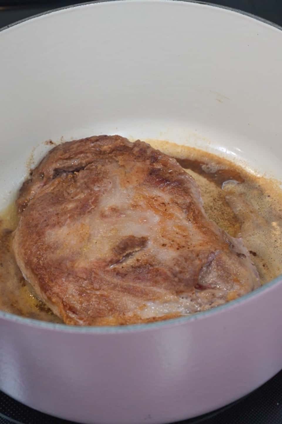 Preheat your oven to 325°F (163°C).
In a large bowl, combine the flour, salt, pepper, and garlic powder. Dredge the pork shoulder or butt in the flour mixture, ensuring it's well-coated.
In a large Dutch oven or oven-safe pot, heat the butter and olive oil over medium-high heat. Brown the pork on all sides until it develops a golden crust. This step helps seal in the juices.
