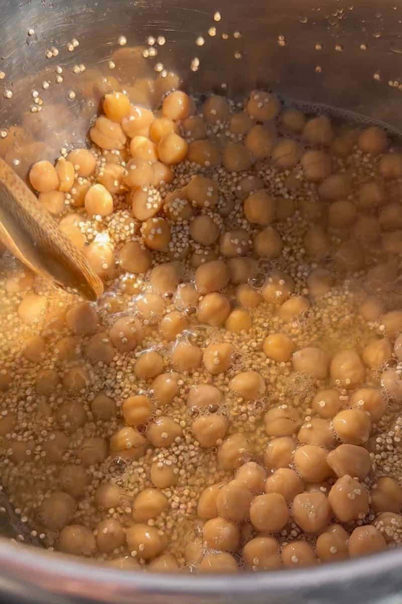 Start by adding the quinoa, chickpeas and the chicken broth in the instant pot.