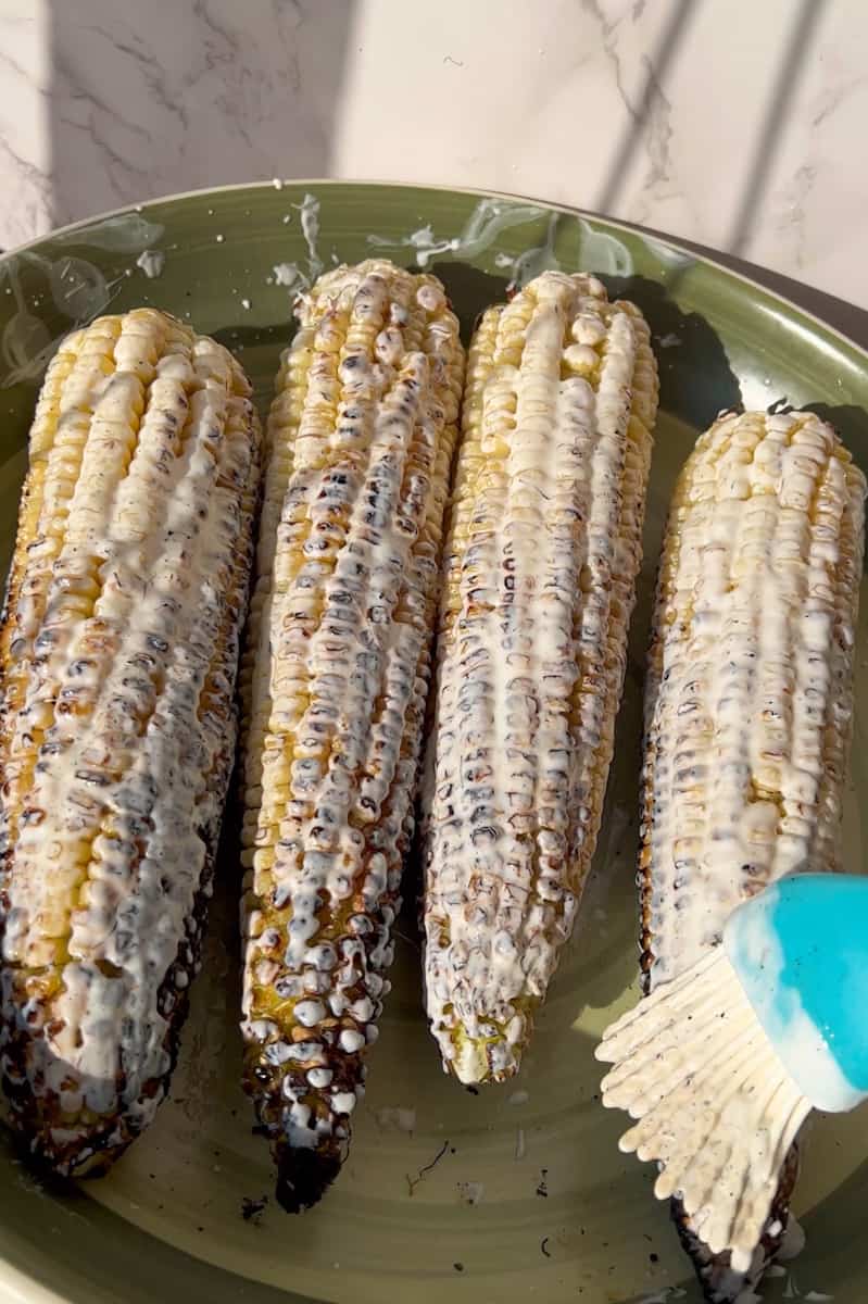 Grill the corn for 10 minutes, turning once halfway. In another bowl, add the lime juice, sour cream and mayo. Brush the grilled corn with the mayo sour cream sauce.