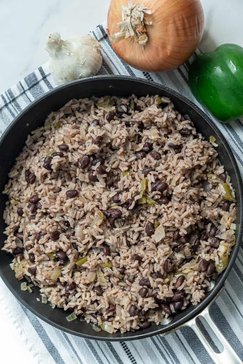 This Moro Rice (Moros y Cristianos) is made with rice, onion, bell pepper, garlic, adobo, black beans, orange juice and simmered to perfection.