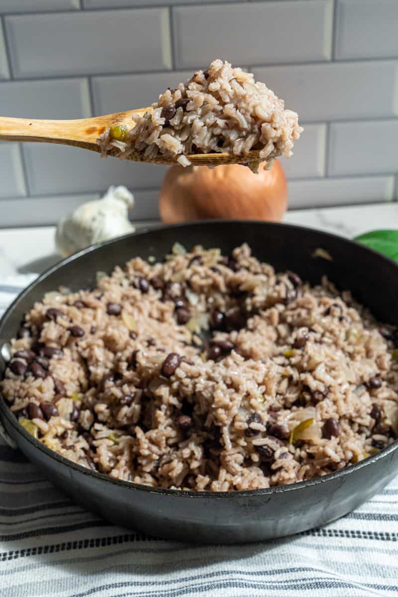 This Moro Rice (Moros y Cristianos) is made with rice, onion, bell pepper, garlic, adobo, black beans, orange juice and simmered to perfection.