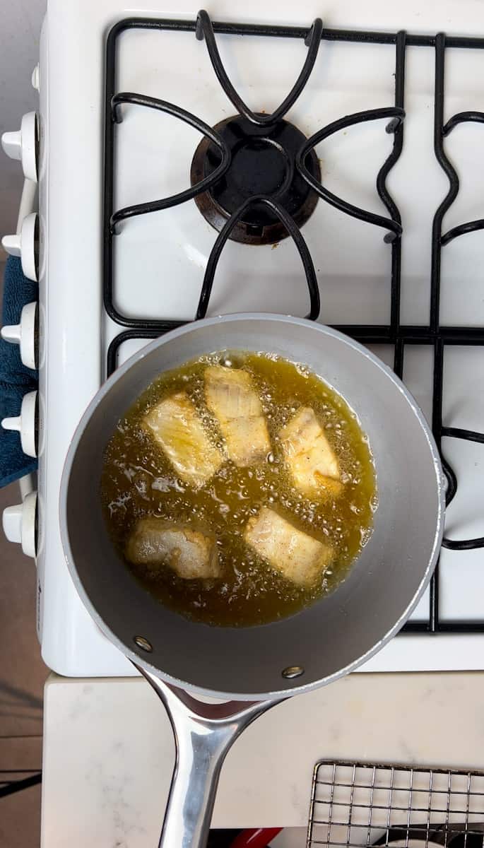 In a small saucepan on medium heat, heat up ½ inch oil. Oil should read 375°F on a candy thermometer. Fry the fish for 3 minutes on each side, until the fish reaches 145 degrees F.