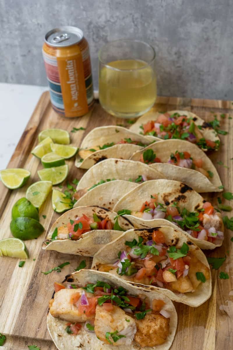 This Ensenada Fish Tacos Recipe is made with cod, flour, spices, corn tortillas and served with a delicious pico de gallo.
