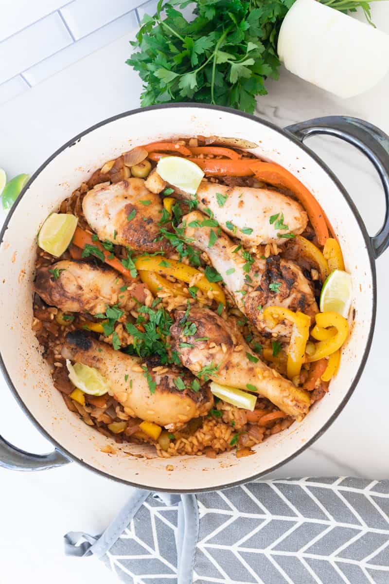 This Cuban Arroz con Pollo Recipe is made with arborio rice, drumsticks, adobo, sofrito, saffron, peppers, broth and white wine.