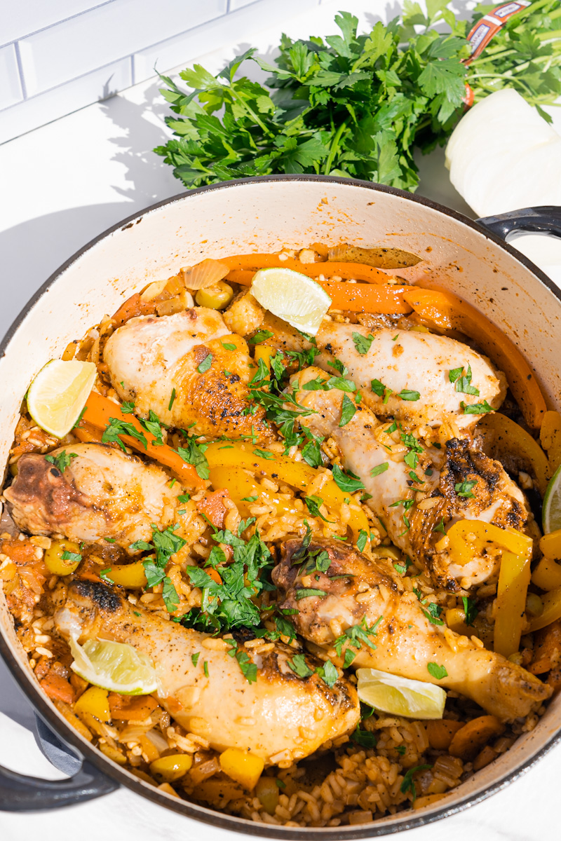 This Cuban Arroz con Pollo Recipe is made with arborio rice, drumsticks, adobo, sofrito, saffron, peppers, broth and white wine.