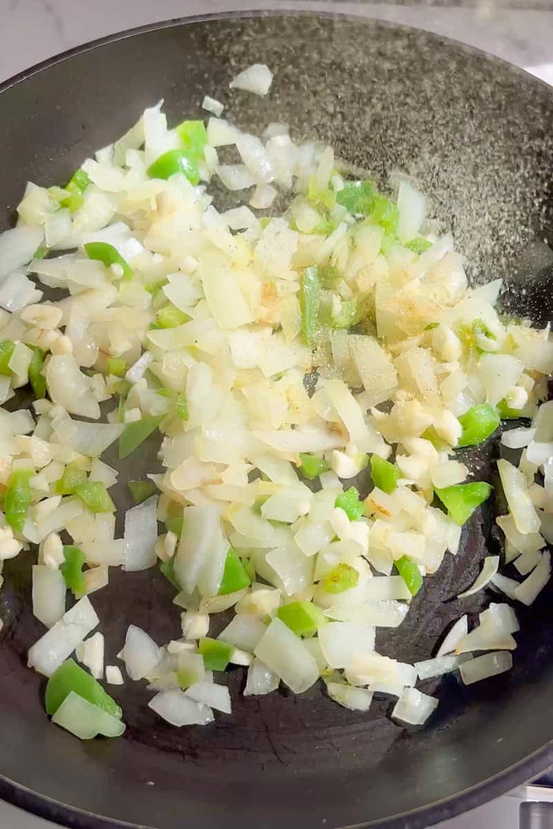 Bring a large saucepan on medium high heat and heat up the oil. When the oil shimmers, add the onion and peppers and cook until they’re soft, about 5-10 minutes. Add garlic and cook until fragrant, about 1 minute. 