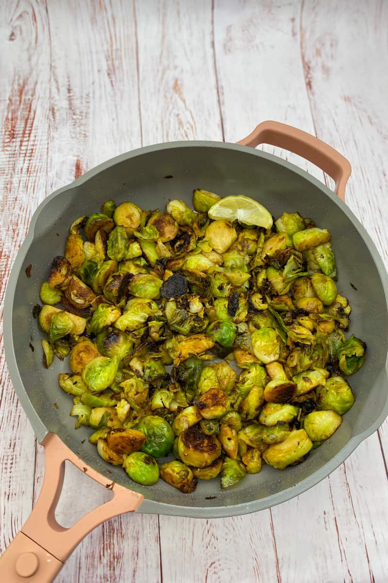Remove the lid and taste the Brussels sprouts. Adjust the seasoning if needed. Transfer the sauteed lemon Brussels sprouts to a serving dish and serve hot alongside the broiled lemon chicken thighs. Enjoy this Lemon Brussels Sprouts Recipe. 