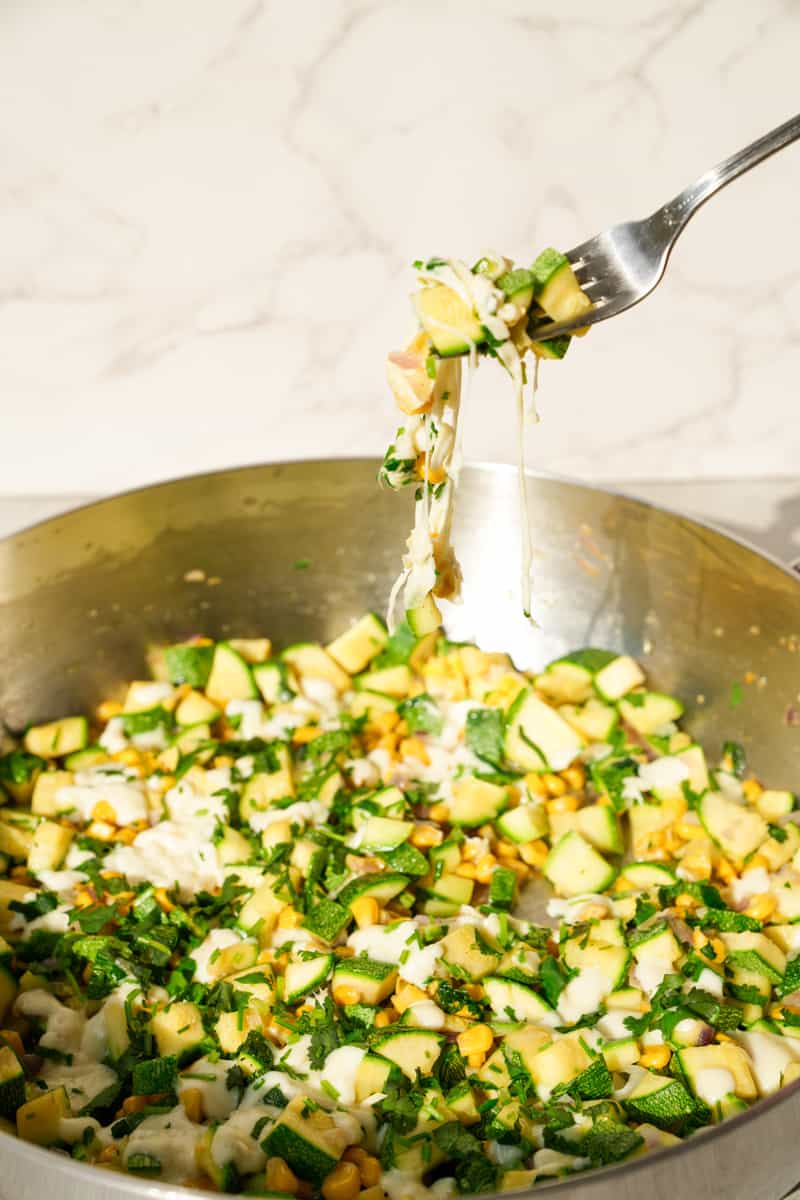 This Calabacitas Recipe (Mexican Zucchini with Corn) is vegetarian dish made with zucchini, corn, cheese and cilantro. 