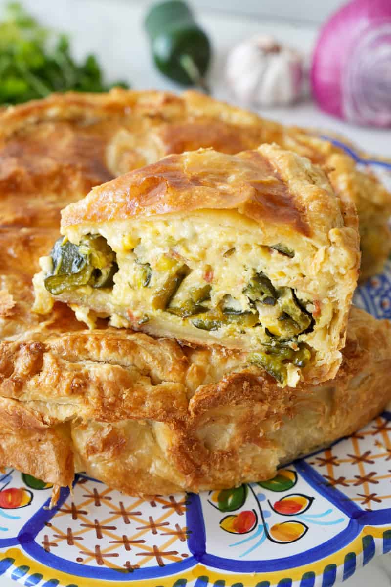 This Mexican Quiche Recipe is made with poblano peppers, bacon, cheese, onion, garlic, eggs, jalapeños, cilantro, and baked in a pie crust.