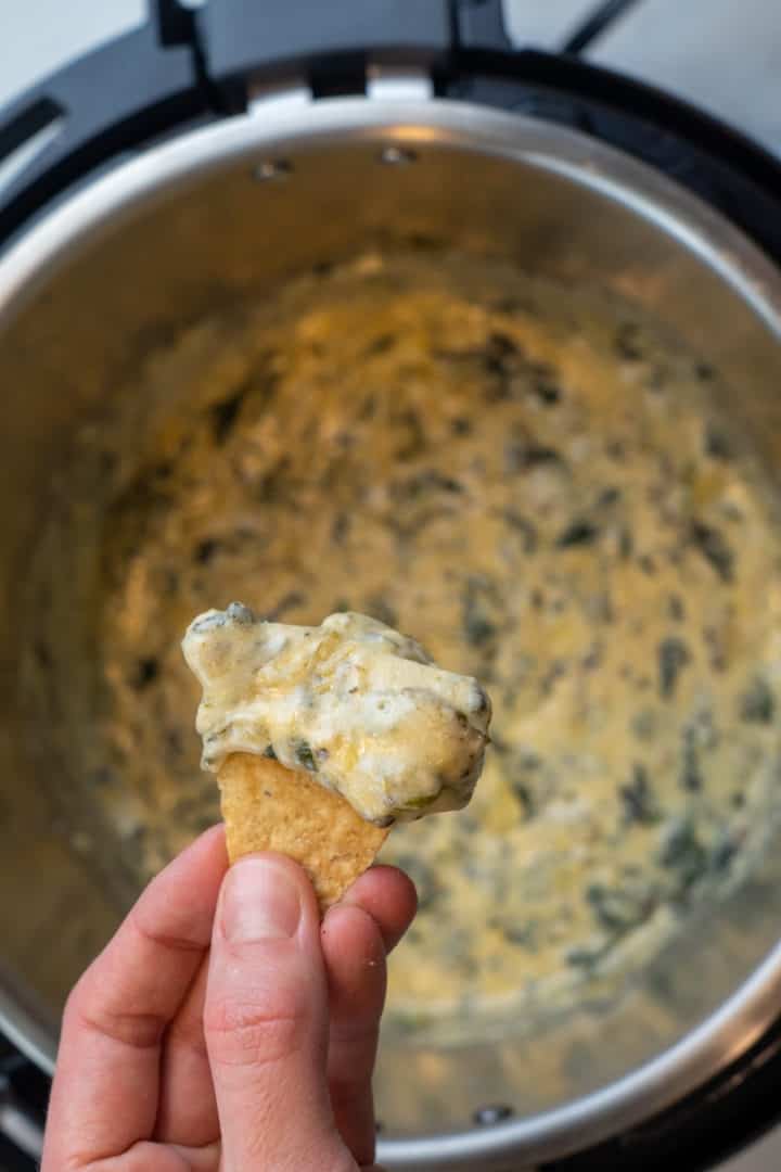 This Instant Pot Spinach Artichoke Dip Recipe is made with frozen spinach, artichokes, cream cheese, mayonnaise, and cheese.