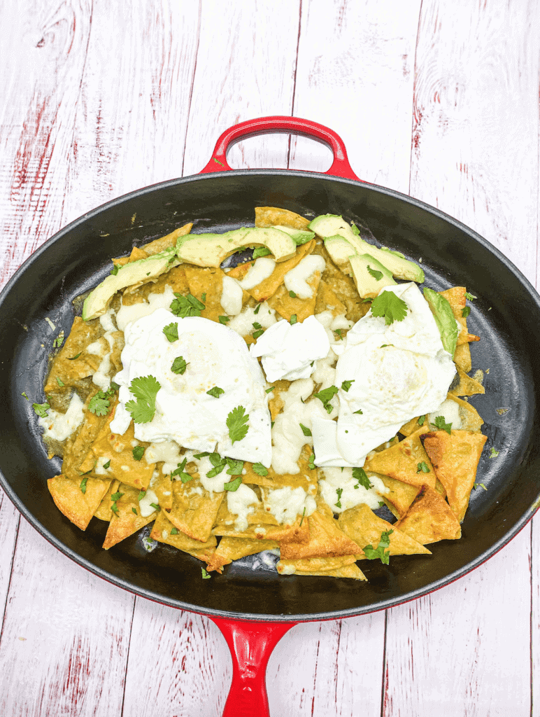 These are Chilaquiles verdes with eggs, avocado, cilantro, queso fresco, and Salsa Verde.