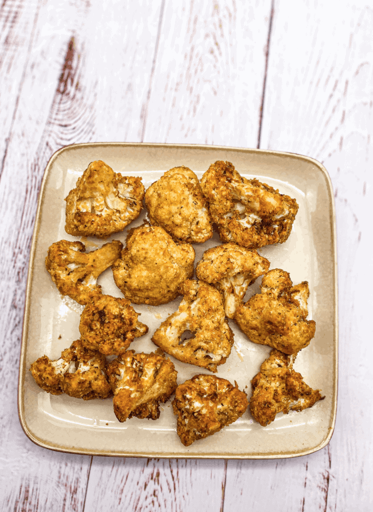 This Air Fryer Buffalo Cauliflower Recipe is made with cauliflower, hot sauce, spices, panko, parmesan cheese and air fried.