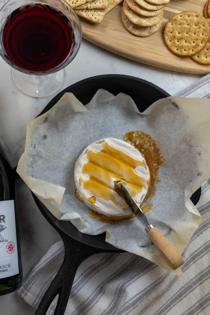 This is a Baked Brie Fig Jam recipe that requires only three ingredients: brie, honey or fig jam and your choice of nuts.