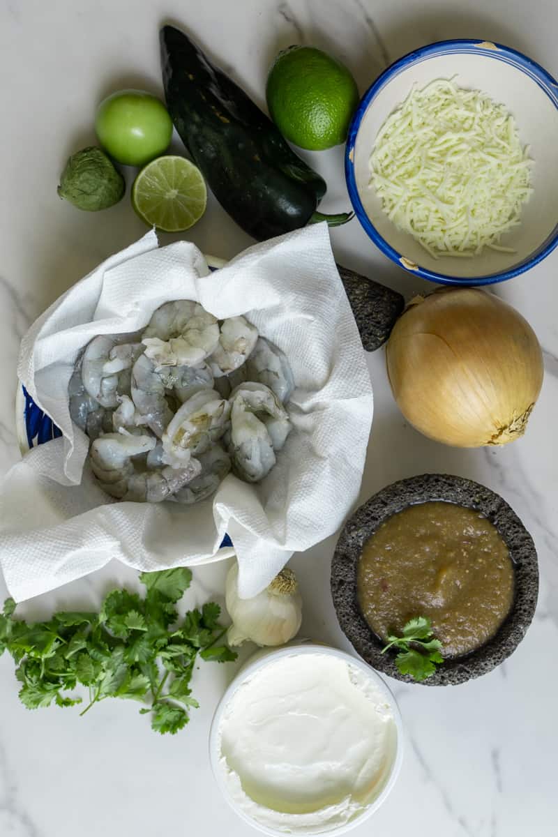 You'll only need a few simple ingredients to make this. The exact measurements are listed in the recipe card below. Here's an overview of what you'll need: Shrimp
Onion
Garlic
Poblano peppers
Sour cream
Salsa verde
Mozzarella
Limes