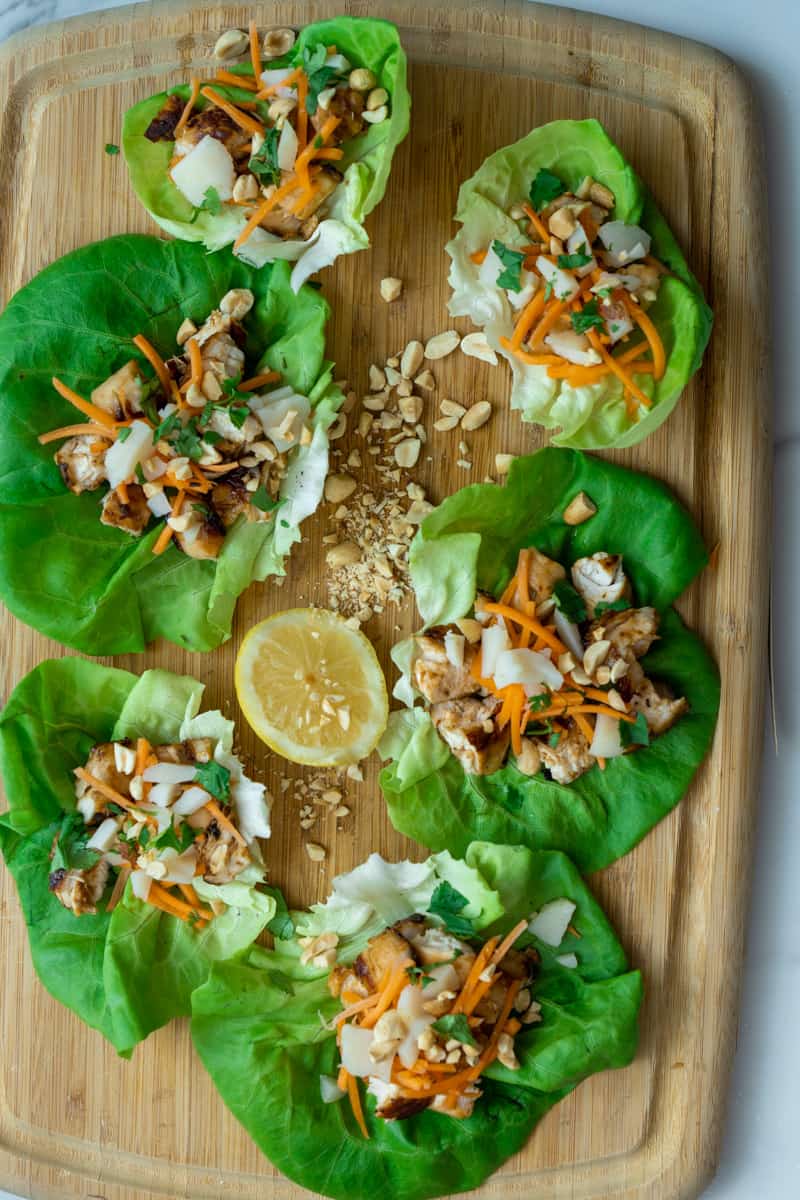 These Teriyaki Chicken Lettuce wraps marinated with teriyaki sauce and topped with water chestnuts, shredded carrots, chopped peanuts and cilantro. 