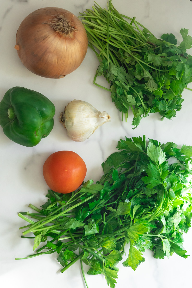 There are many variations but this Puerto Rican Sofrito Recipe is made with cilantro, parsley, onion, pepper, garlic, and tomato.