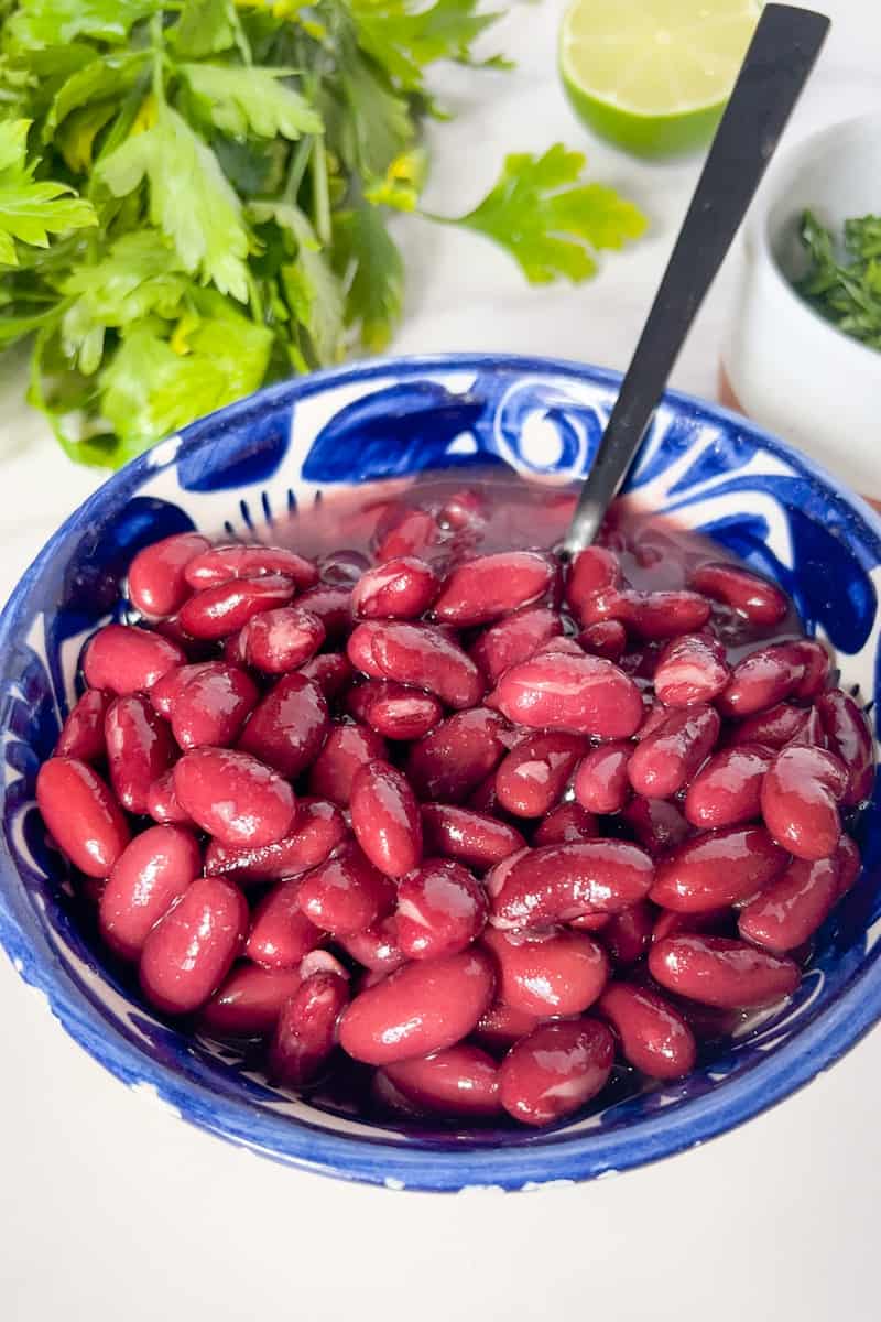 Open the lid and remove the bay leaves from the cooked beans.If you prefer a thicker consistency, you can mash some of the beans with a spoon or potato masher. Taste the beans and adjust the seasoning as needed, adding salt and pepper if desired.