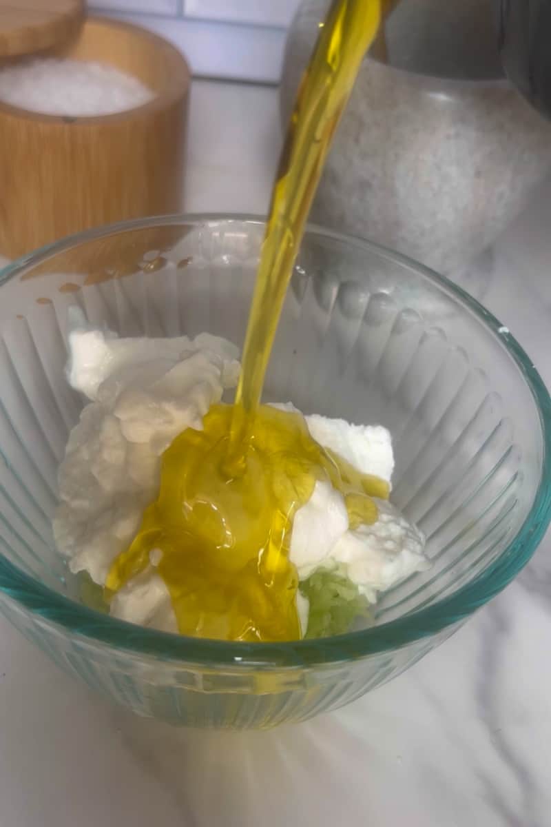 Add the grated cucumber to the yogurt mixture and mix well to combine. Taste the tzatziki and adjust the salt if needed.