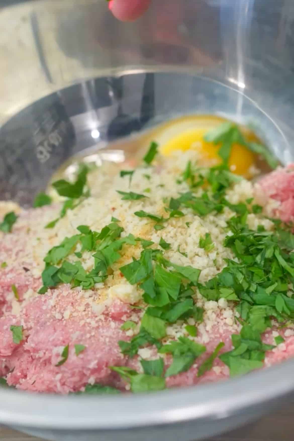 Prepare the Meatballs: In a large mixing bowl, combine the ground beef, grated Parmesan cheese, finely chopped parsley, garlic powder, panko breadcrumbs, and egg. Season the mixture with salt and pepper to taste. 