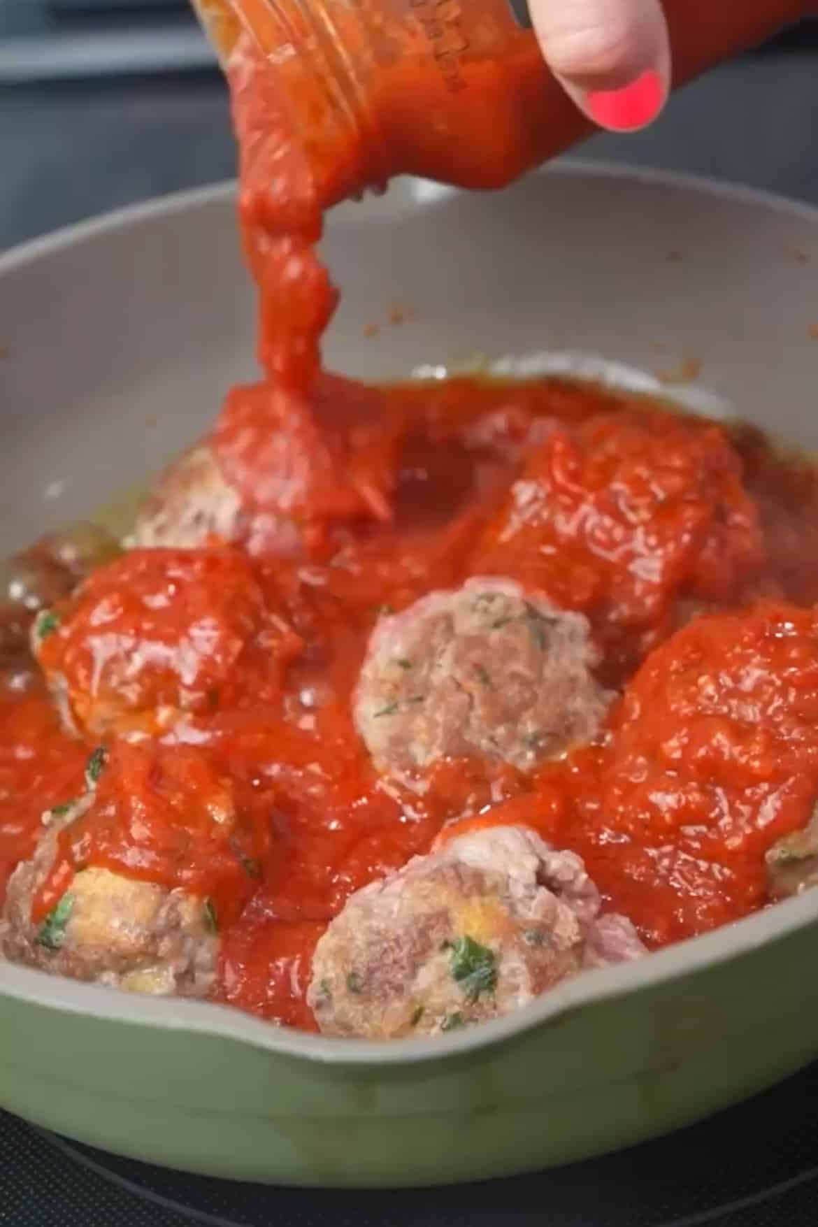 Cook the Meatballs: Heat a large skillet or frying pan over medium-high heat. Add a bit of olive oil to the pan to prevent sticking. Place the meatballs in the hot pan and cook, turning them occasionally, until they are browned on all sides and browned, about 5 minutes on each side. Lower the heat and pour the sauce over the meatballs. Cover and cook for about 10-15 minutes.