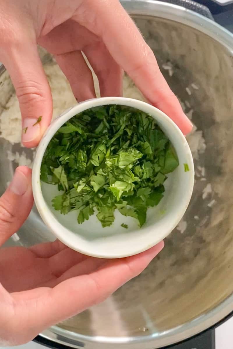 Revuelva el arroz y agregue la ralladura de limón, el jugo de limón y el cilantro. 