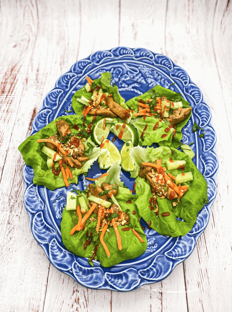 These Teriyaki Chicken Lettuce wraps marinated with sesame oil, soy sauce, Sriracha and garnished with peanuts, carrots and cucumber!