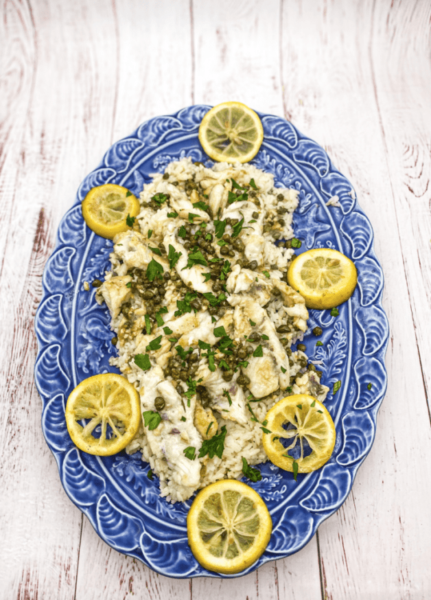 This Mangrove Snapper Recipe is made with butter, garlic, lemon, capers, garnished with parsley and served over rice.