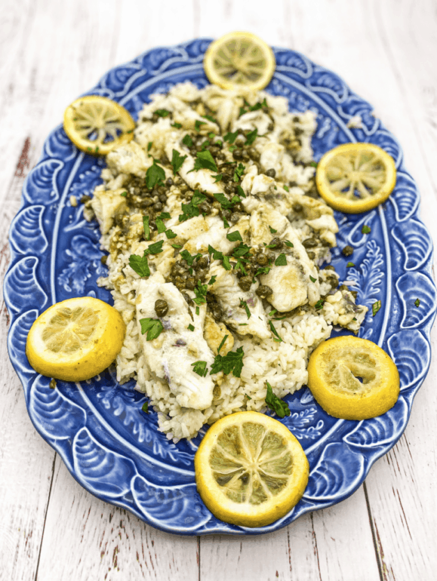 This Mangrove Snapper Recipe is made with butter, garlic, lemon, capers, garnished with parsley and served over rice.