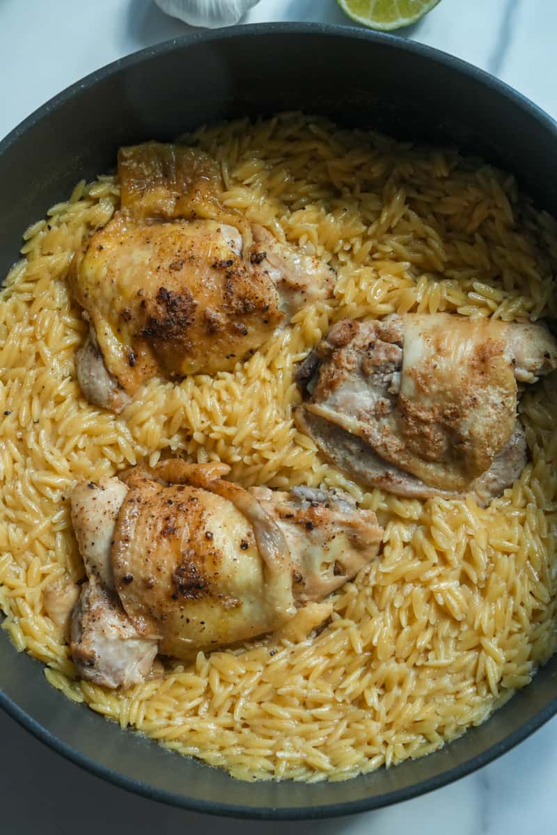 While the orzo is cooking, shred the cooked chicken into bite-sized pieces, discarding the bones and skin.

Once the orzo is cooked, return the shredded chicken (and any meat that fell into the pot) to the orzo.

Mix well to combine, allowing the chicken to warm through.

Remove the bay leaves.

Serve the Chicken Orzo hot, garnished with fresh herbs if desired.