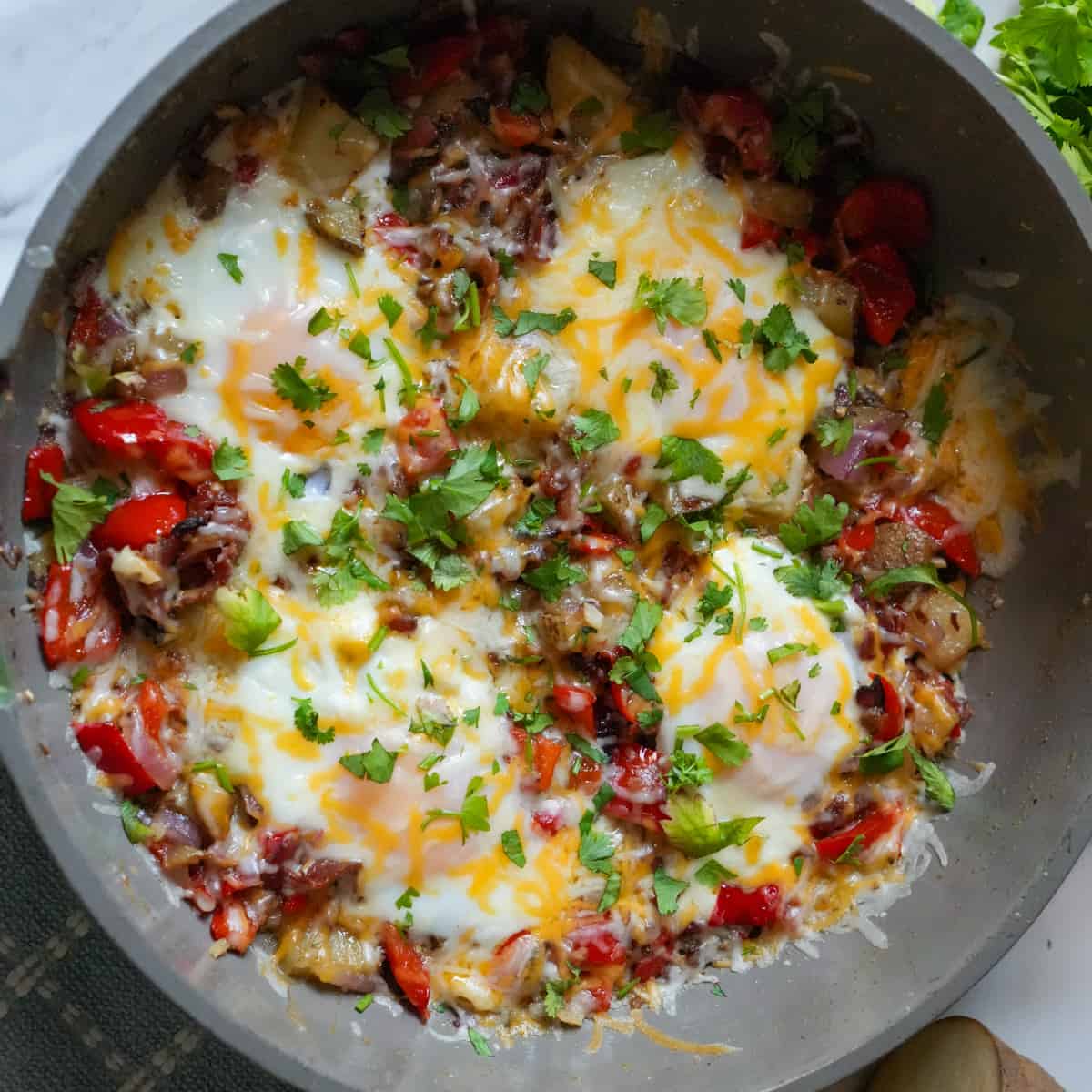 Savor the bold flavors of our Chorizo Breakfast Skillet: sizzling chorizo sausage paired with fluffy scrambled eggs, crispy potatoes, and vibrant bell peppers.