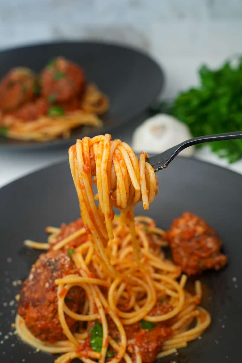 This Homemade Spaghetti and Meatballs Recipe is made with ground beef, panko crumbs, parmesan, eggs, parsley and cooked to perfection.