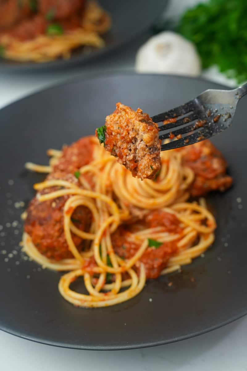 This Homemade Spaghetti and Meatballs Recipe is made with ground beef, panko crumbs, parmesan, eggs, parsley and cooked to perfection.