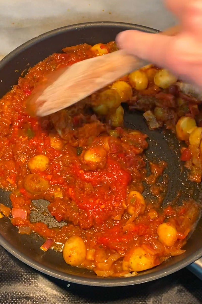 Pour in the Shakshuka Sauce as well as the Harissa and bring to a simmer. Increase the heat to medium and simmer until the sauce has thickened slightly and the potatoes are fork-tender, about 5 minutes. Taste and add more salt and pepper as needed.