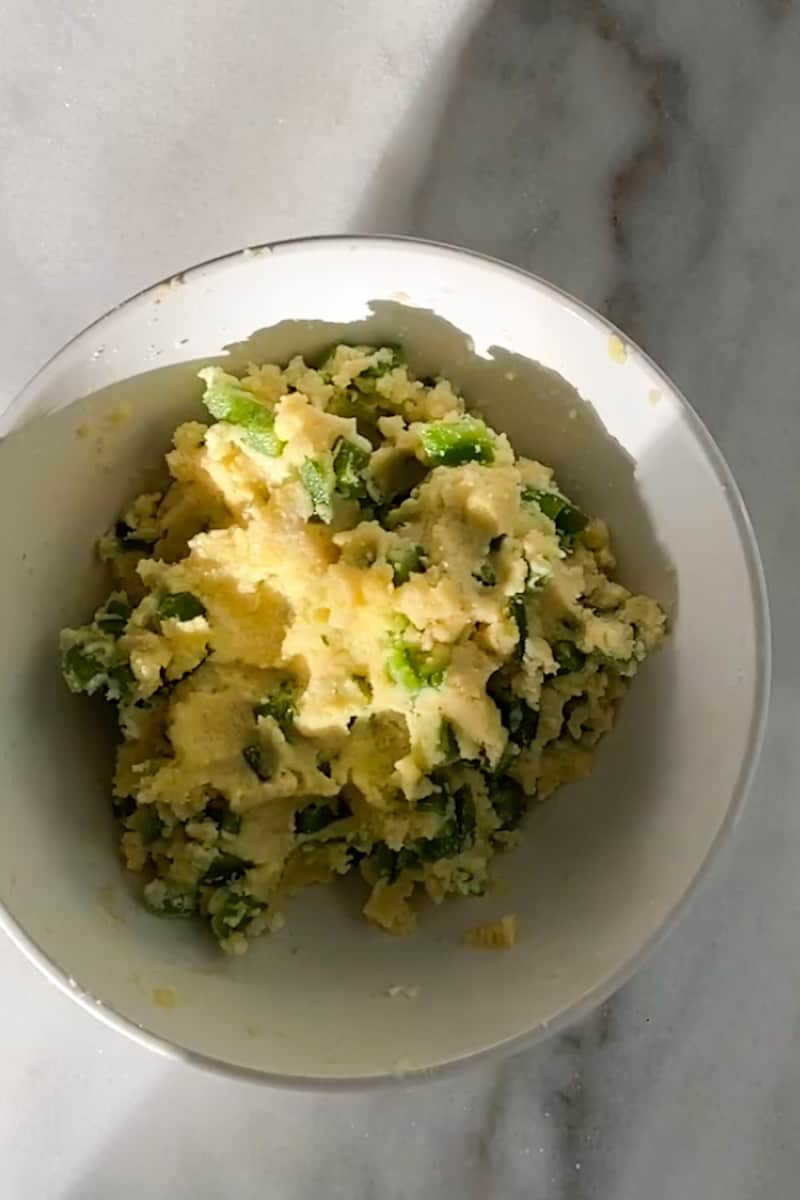 Drop a tablespoon size ball of batter into the oil. Fry for 3 minutes, then use a slotted spoon to flip and fry for another 3 minutes, until golden brown on all sides.